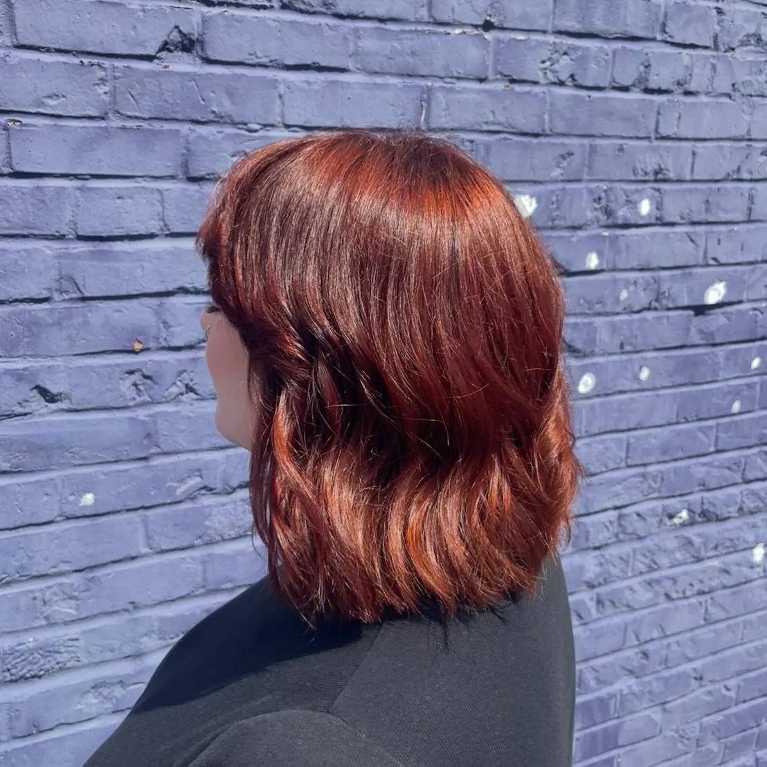 Short copper lob viewed from the back with soft uneven waves