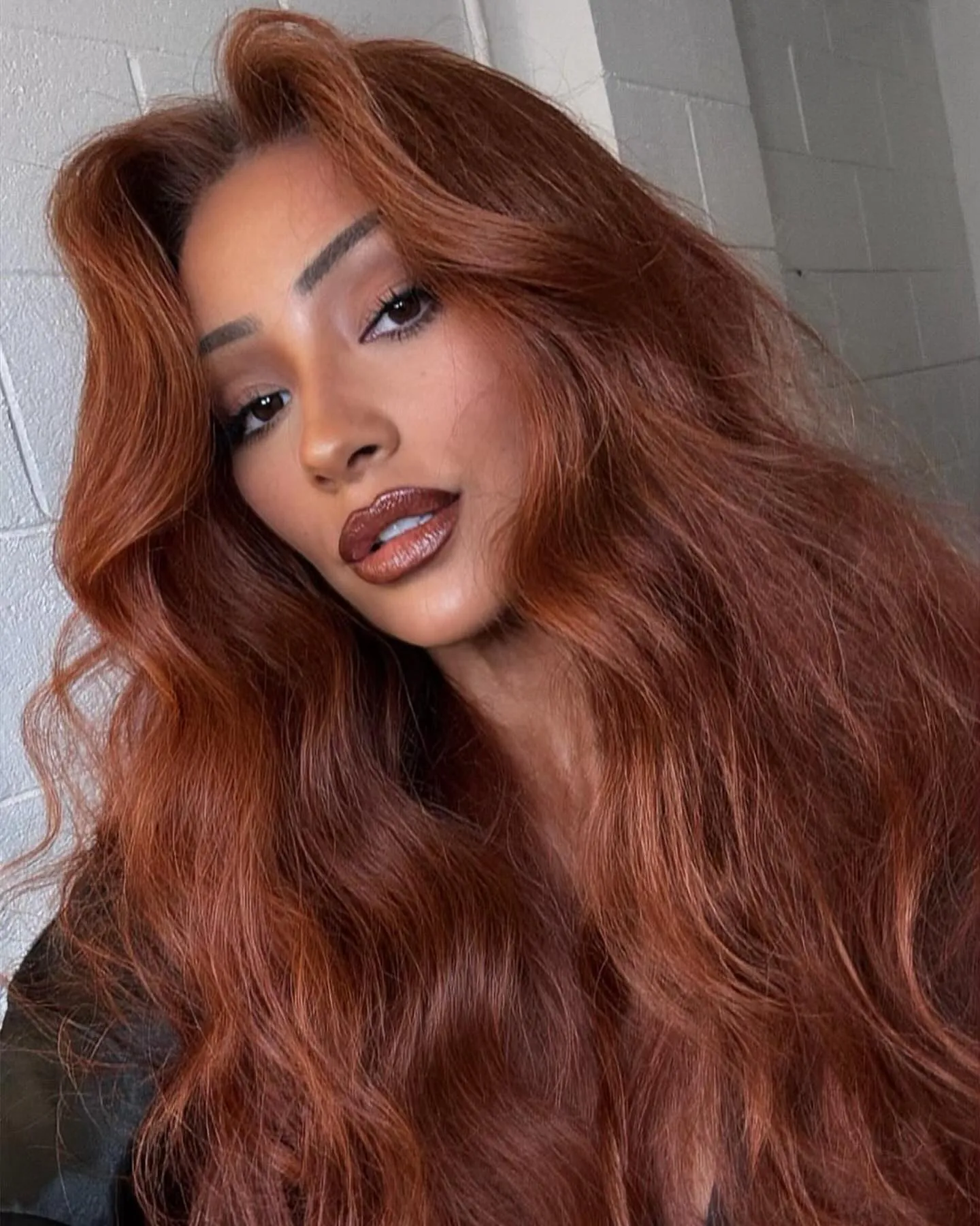 Long copper hair with lifted roots and full flowing waves