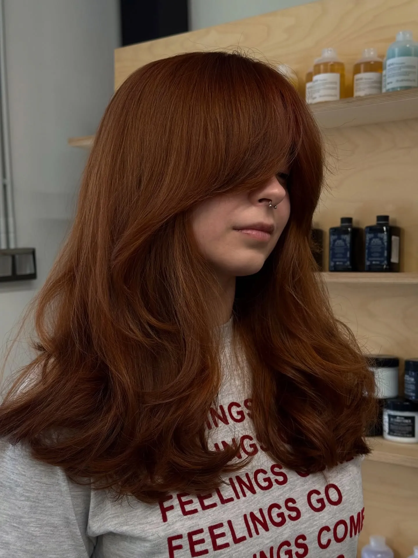 Long copper hair with curtain fringe and full rounded layers
