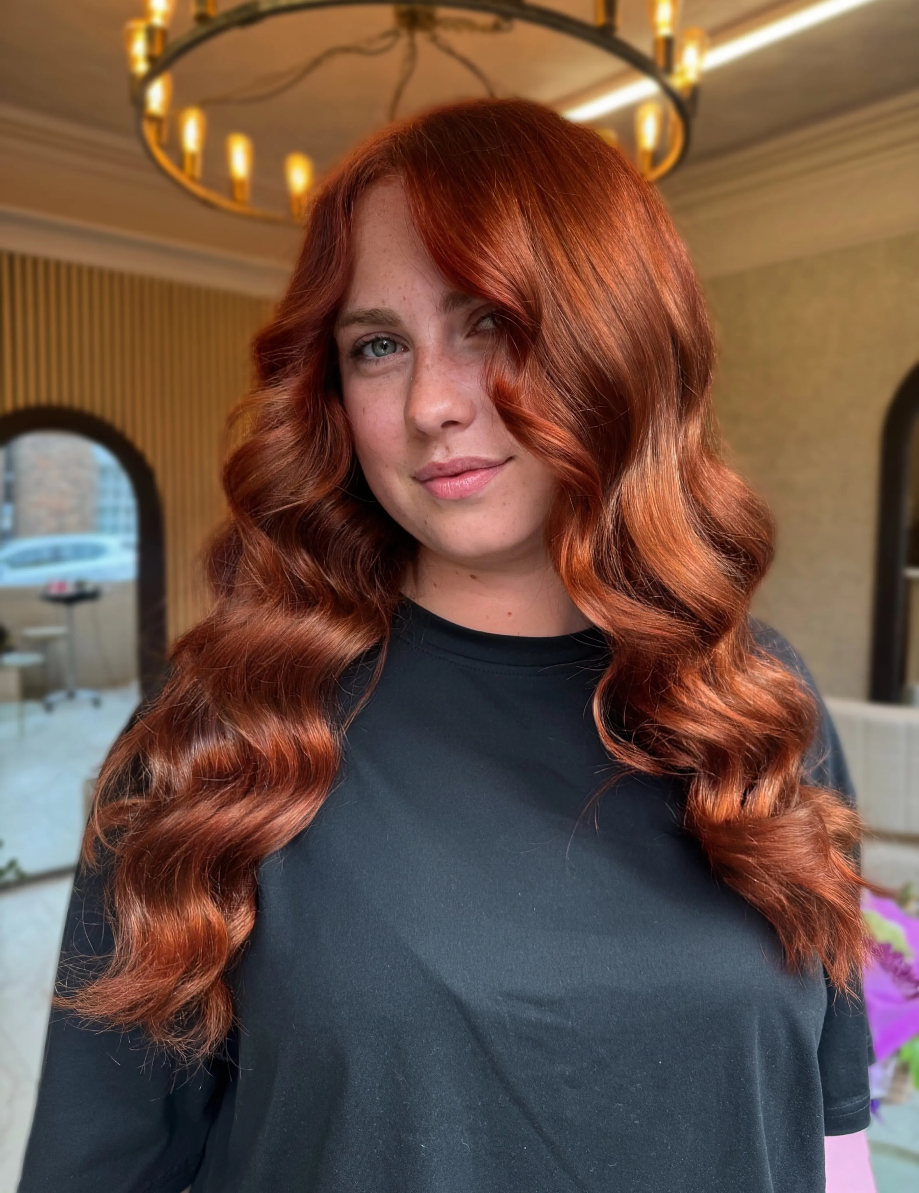 Long deep copper hair styled in polished flowing waves