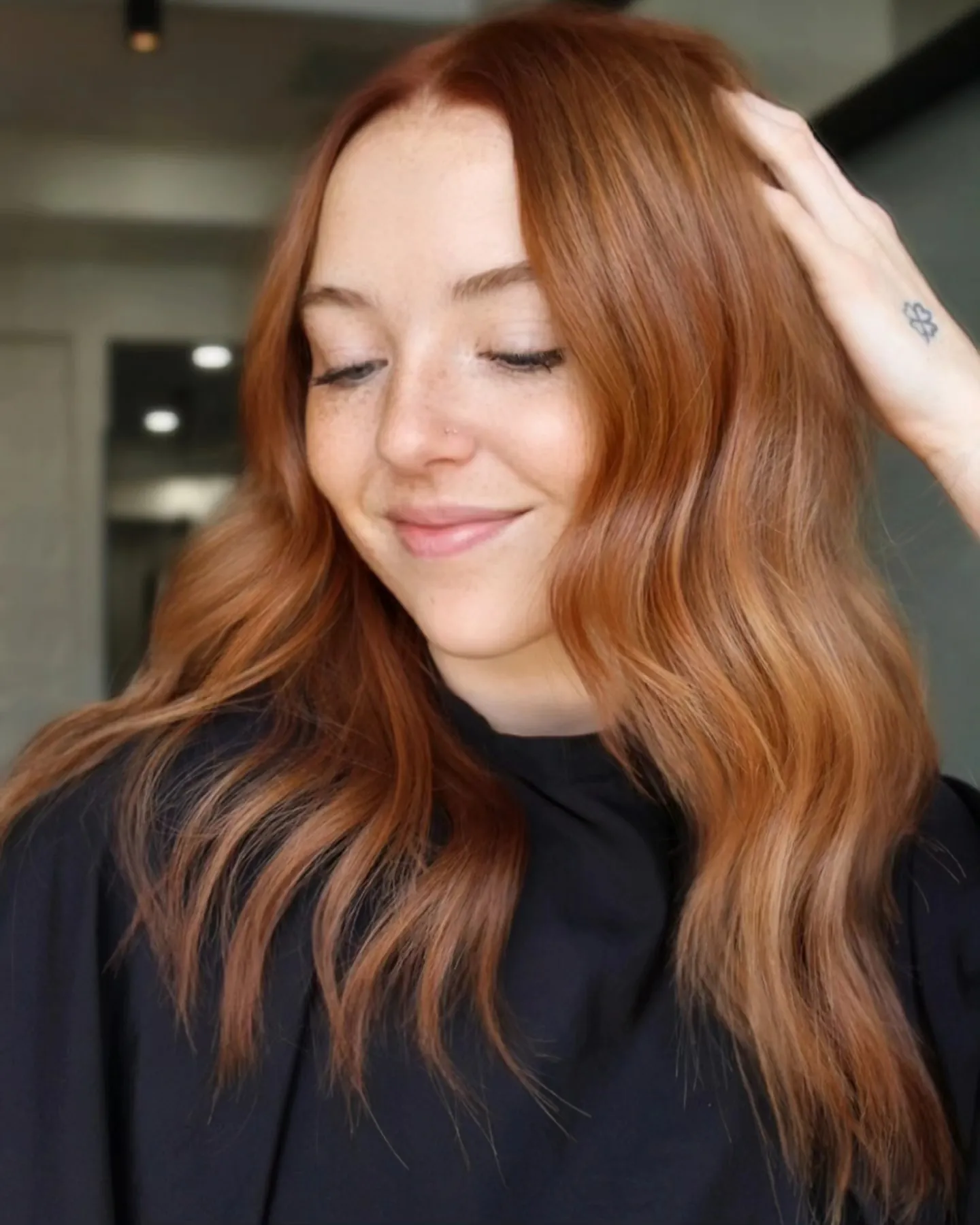 Long copper hair with soft center-parted waves and subtle layering